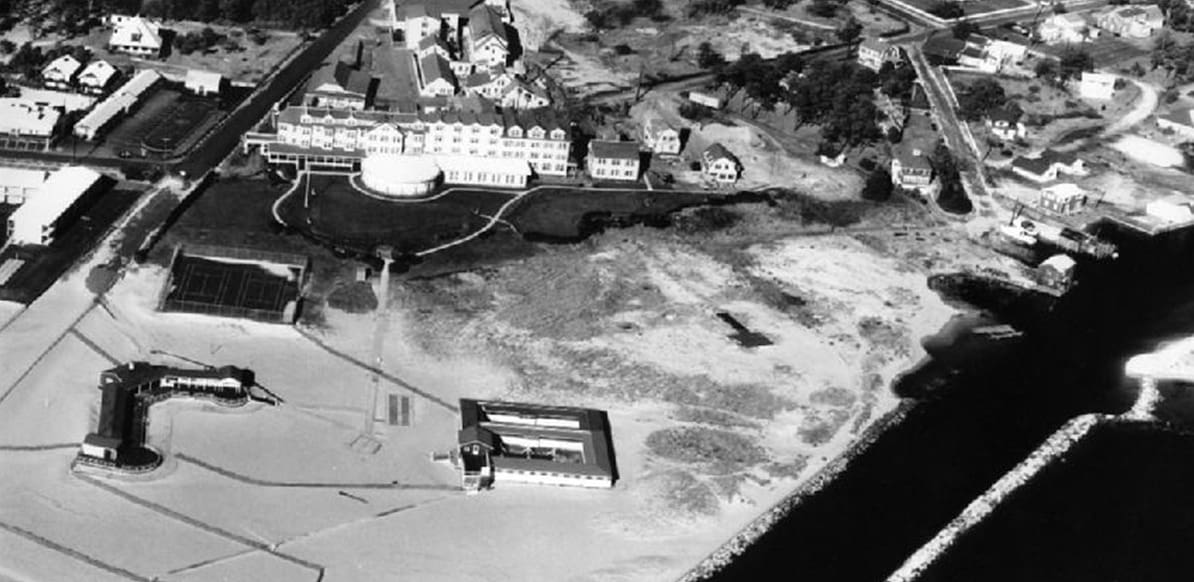 A black and white aerial photo of the beach.