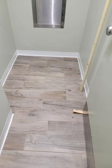 A hallway with wood floors and white trim.
