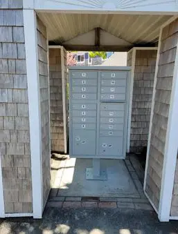 A door to an enclosed area with a large mailbox.