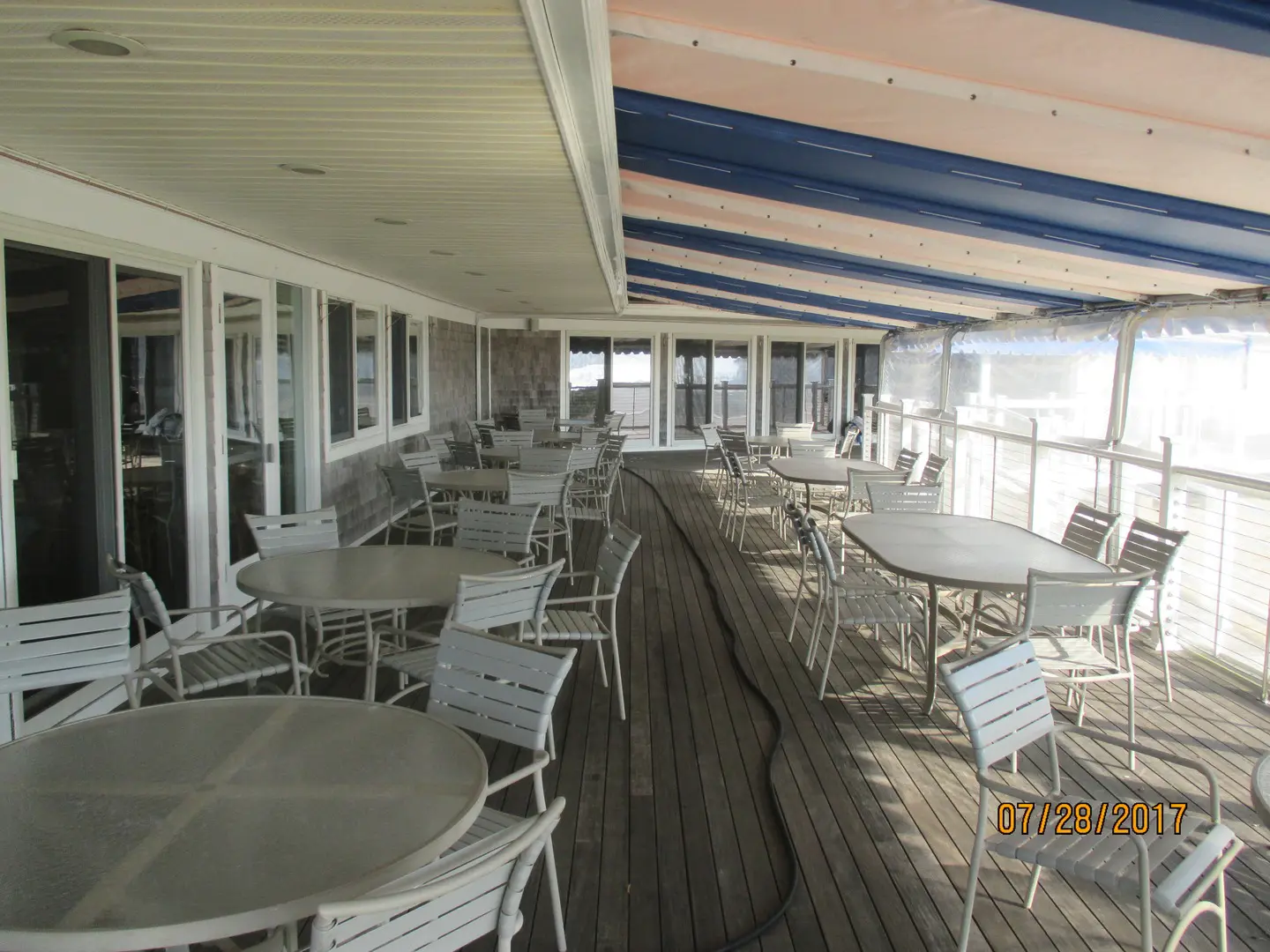 A large deck with tables and chairs on it