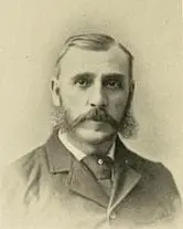A man with a beard and mustache wearing a suit.