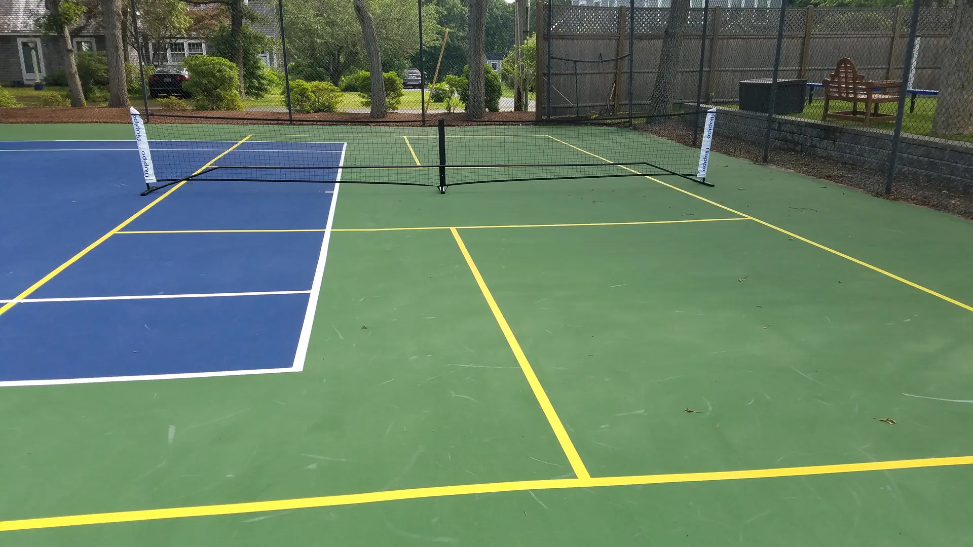 A tennis court with two different colors of blue and yellow.