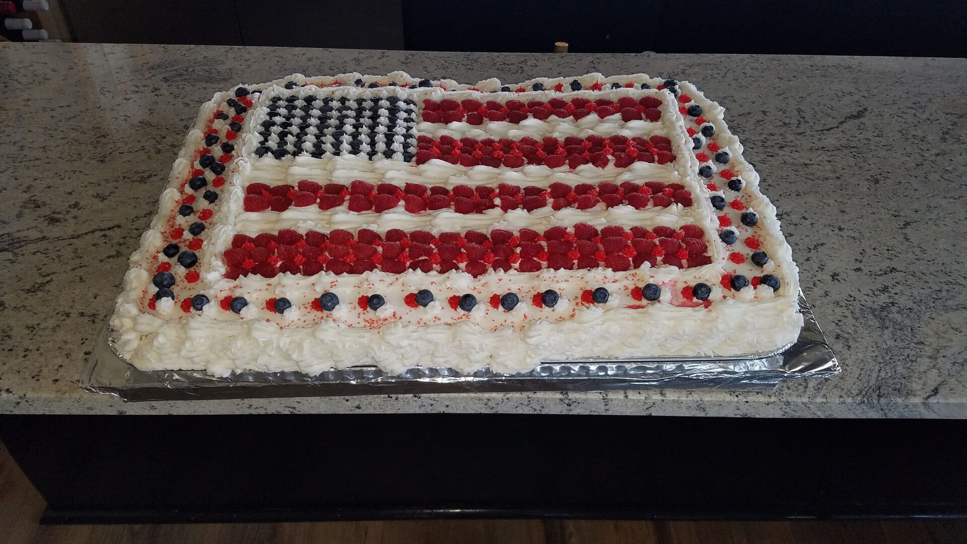 A cake with red, white and blue frosting on it.