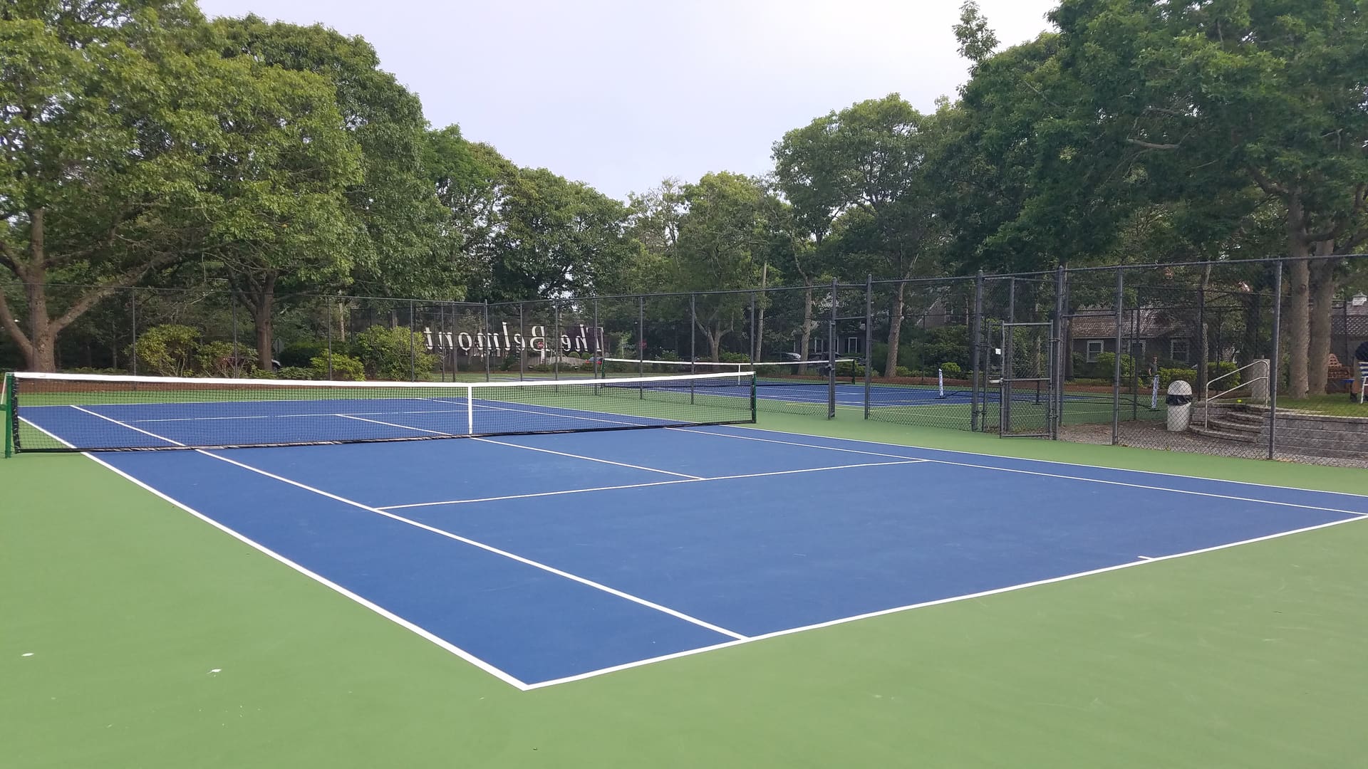 A tennis court with two different colors of blue and green.