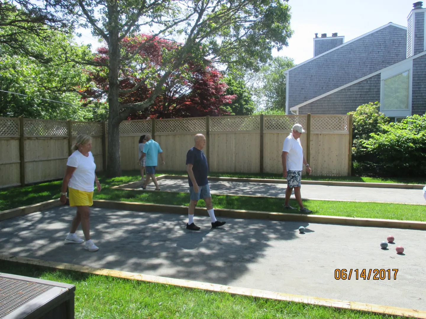 A group of people playing tennis on the court