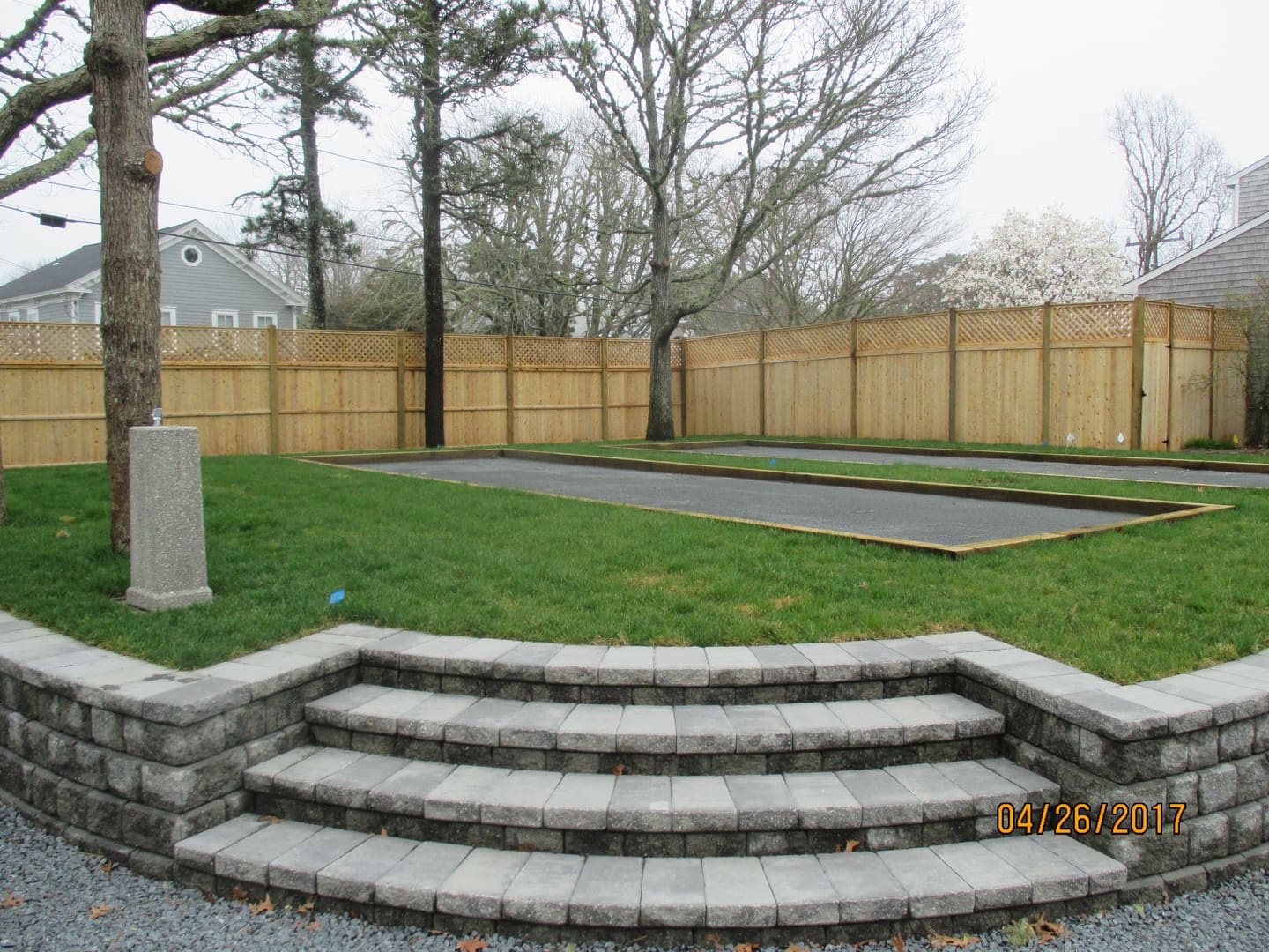 A backyard with stairs and a trampoline.