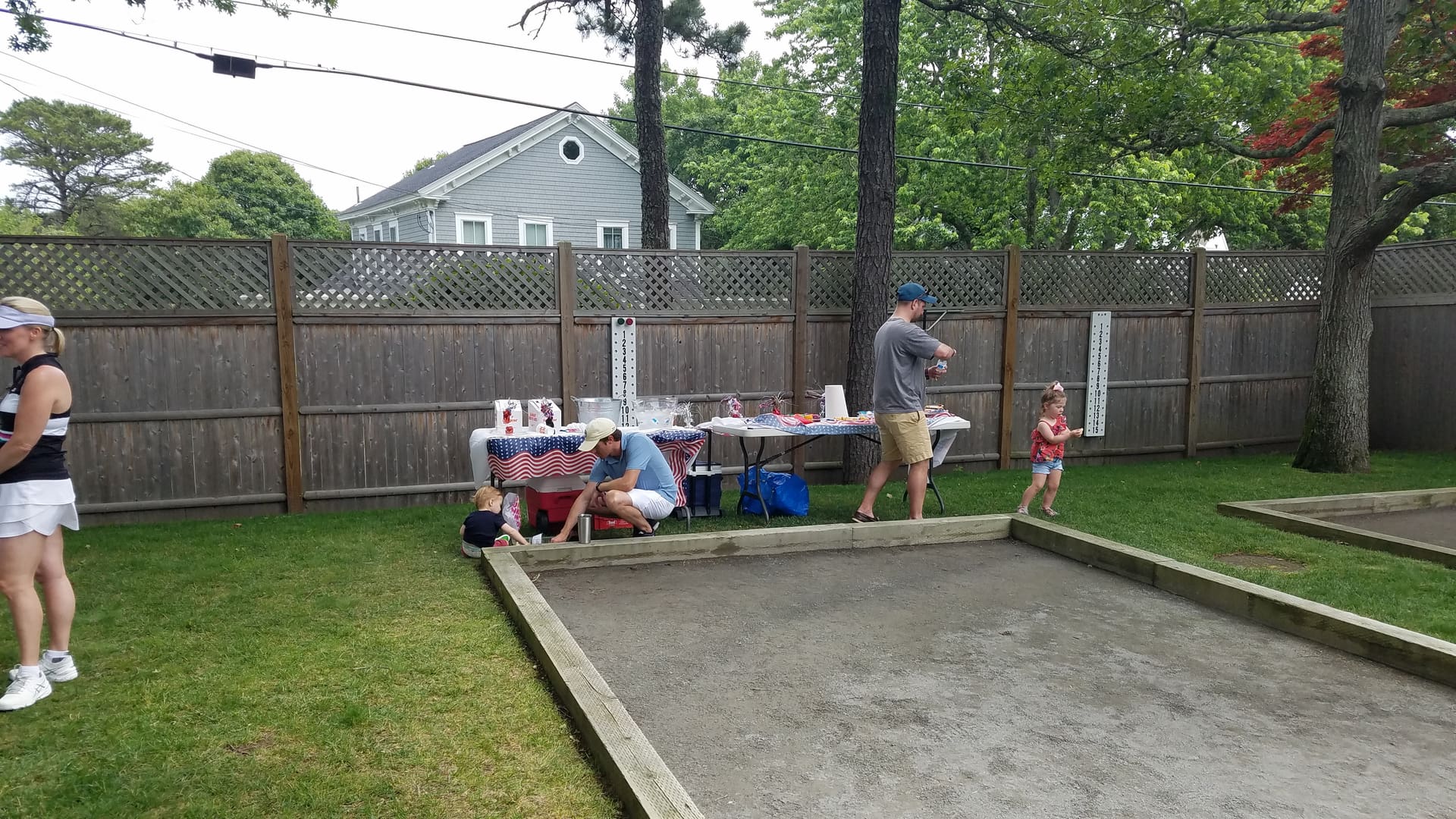 A man and two children playing frisbee golf.