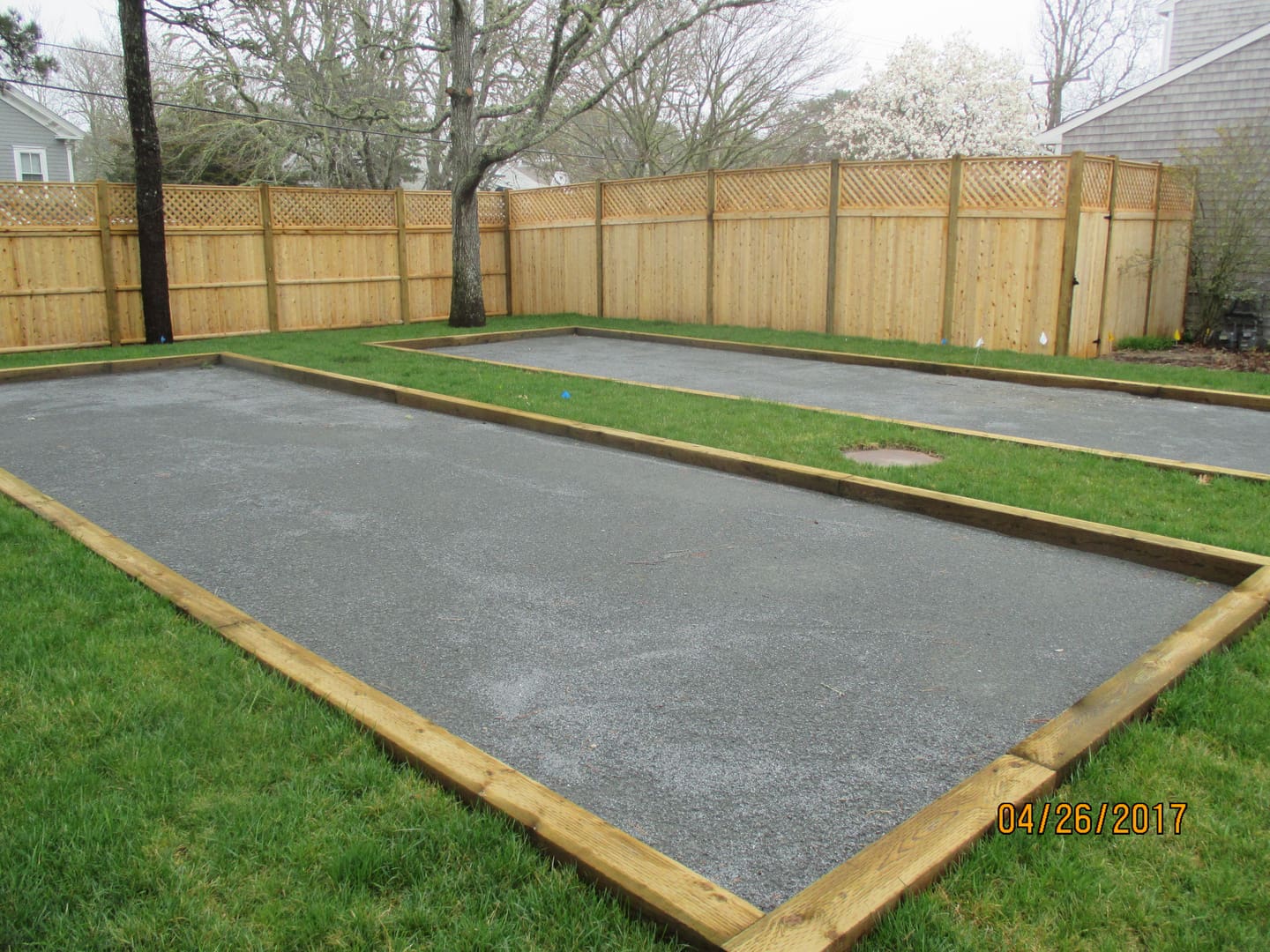 A couple of grass covered concrete pads in the middle of a yard.