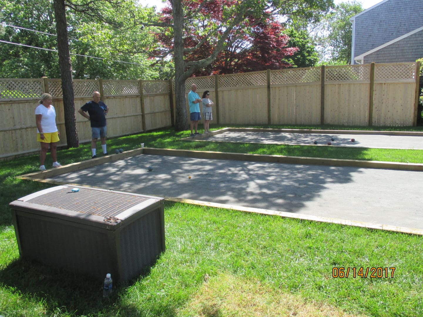 A man and woman playing a game of bocce ball.