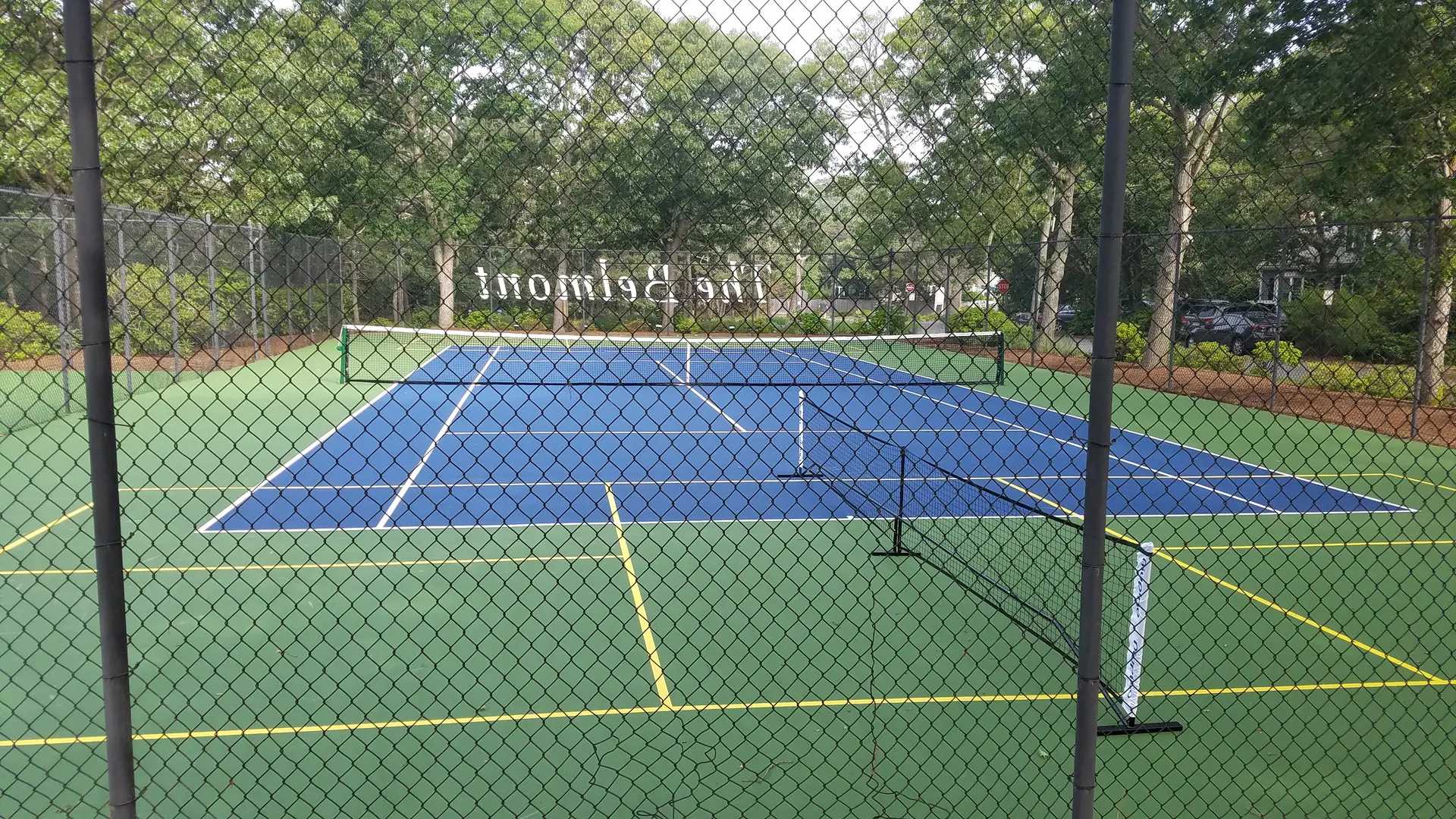 A tennis court with two different colors of blue and yellow.